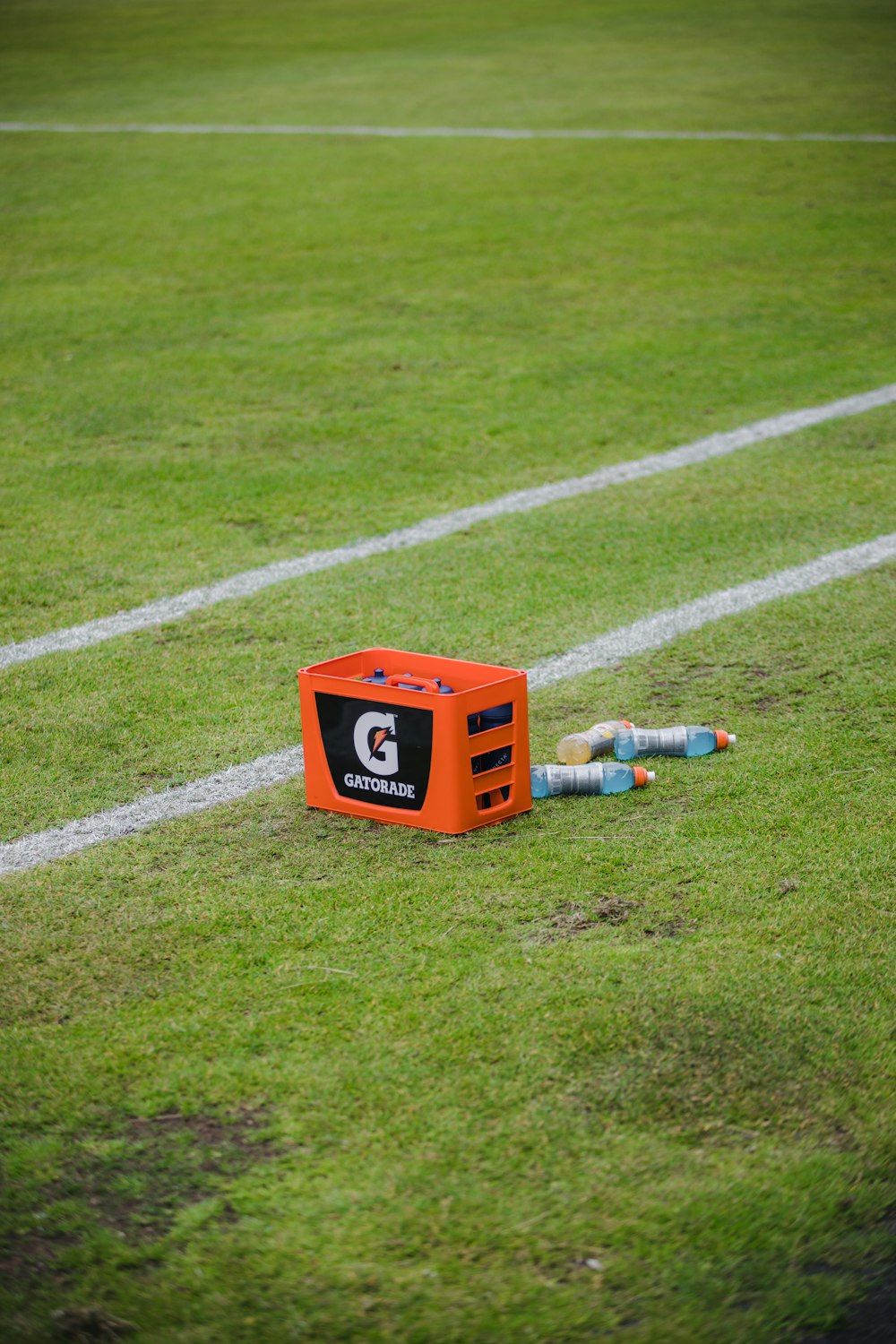 Una caja naranja sentada encima de un campo de fútbol