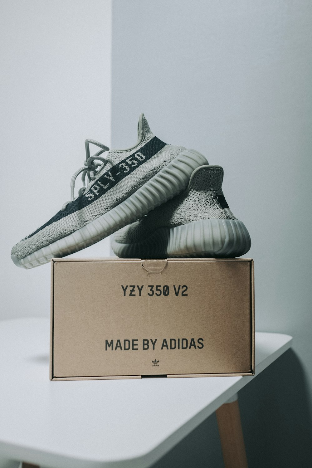 a pair of adidas shoes sitting on top of a cardboard box
