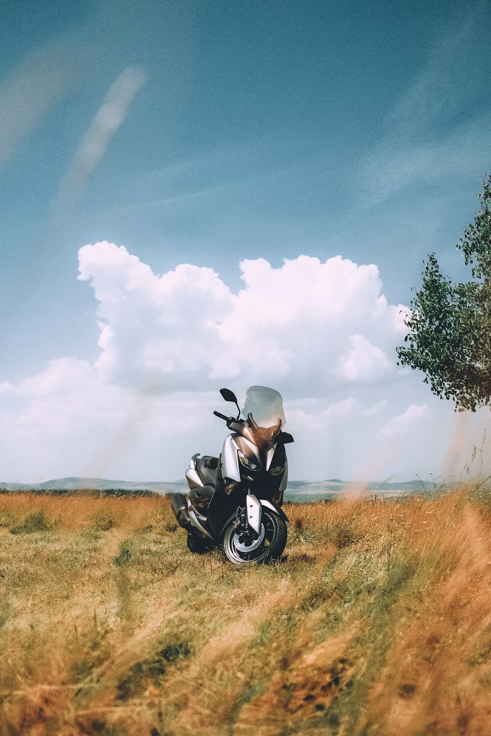 a motorcycle parked in the middle of a field