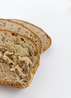 Sliced multigrain bread showing seeds and texture inside.