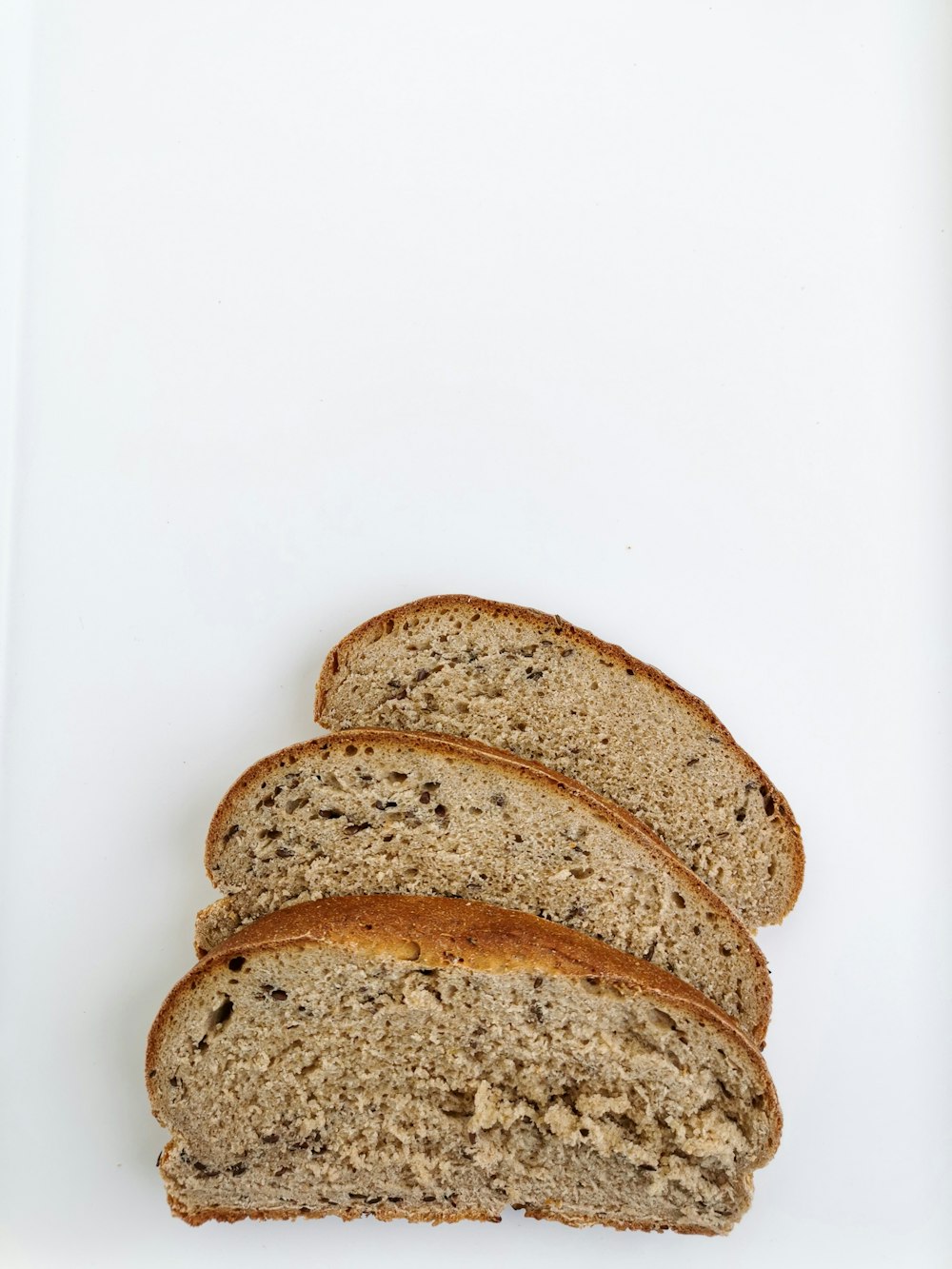 a loaf of whole wheat bread on a white surface