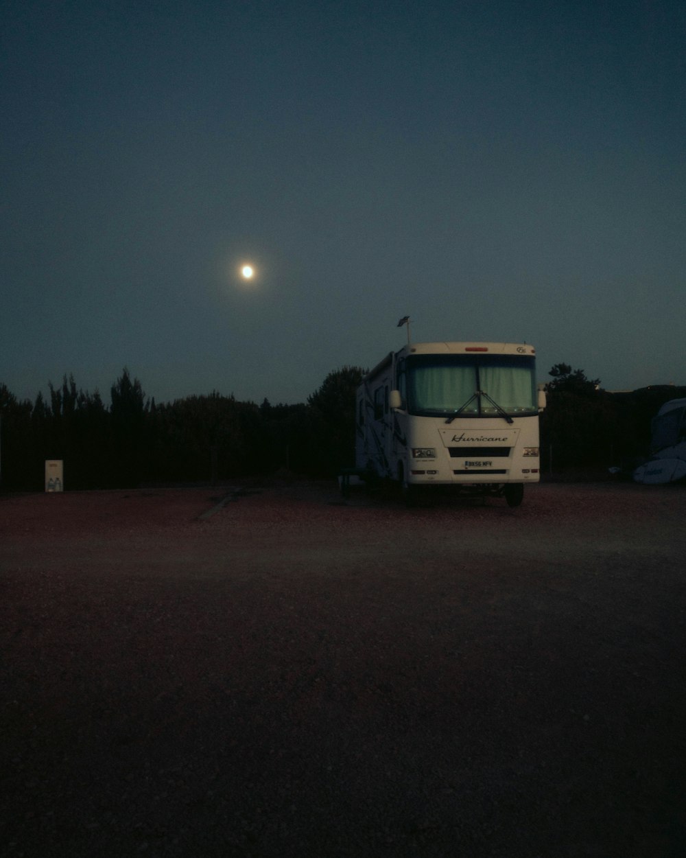 a bus parked in a parking lot at night