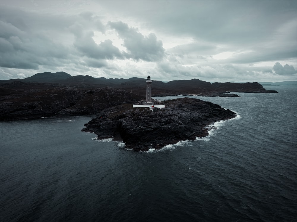 a lighthouse on an island in the middle of the ocean
