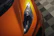 Close-up of a gleaming luxury car hood reflecting the bright, clean workshop lights at Cartamin.
