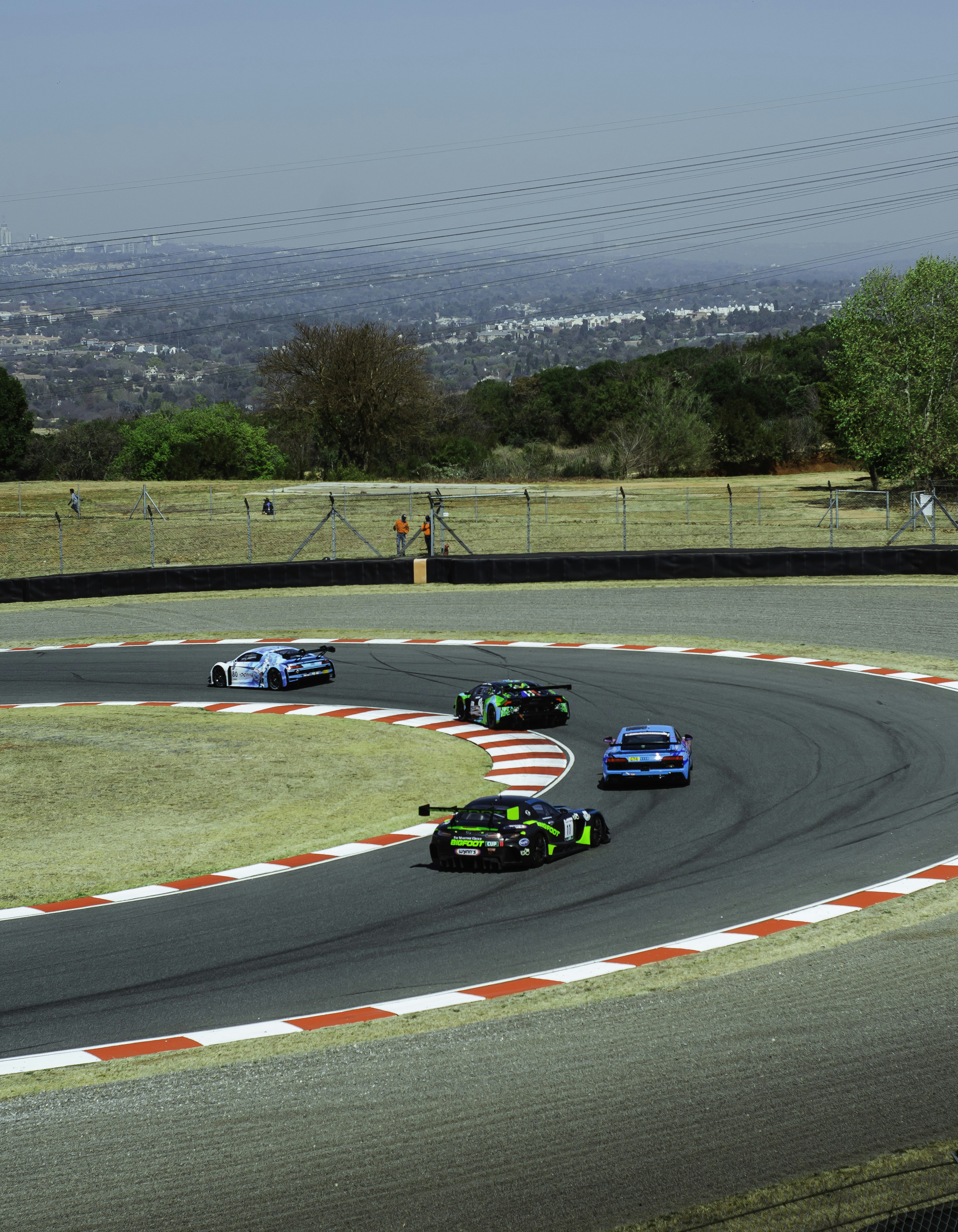 A group of racing cars driving around a track photo – Free Car Image on ...