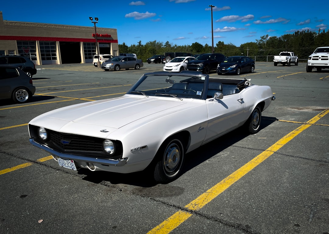 a white car is parked in a parking lot, Cool-looking Camaro