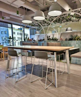 A sturdy fiberglass and aluminum table set up in a stylish office lounge.