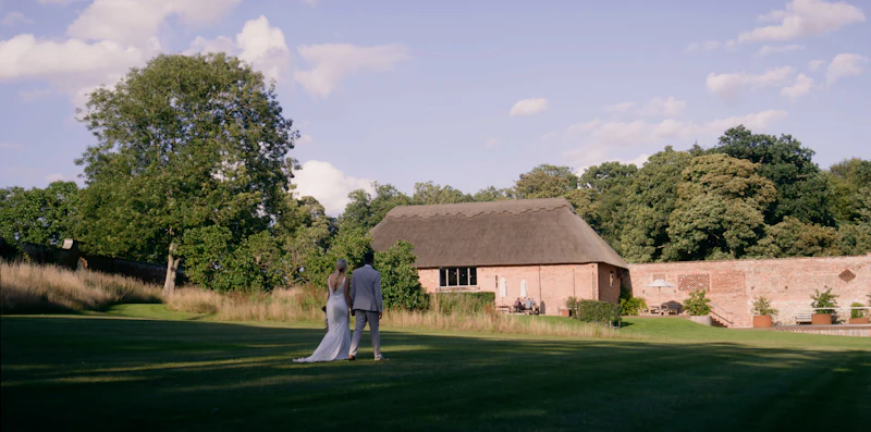 A bride and groom walking together towards their wedding venue