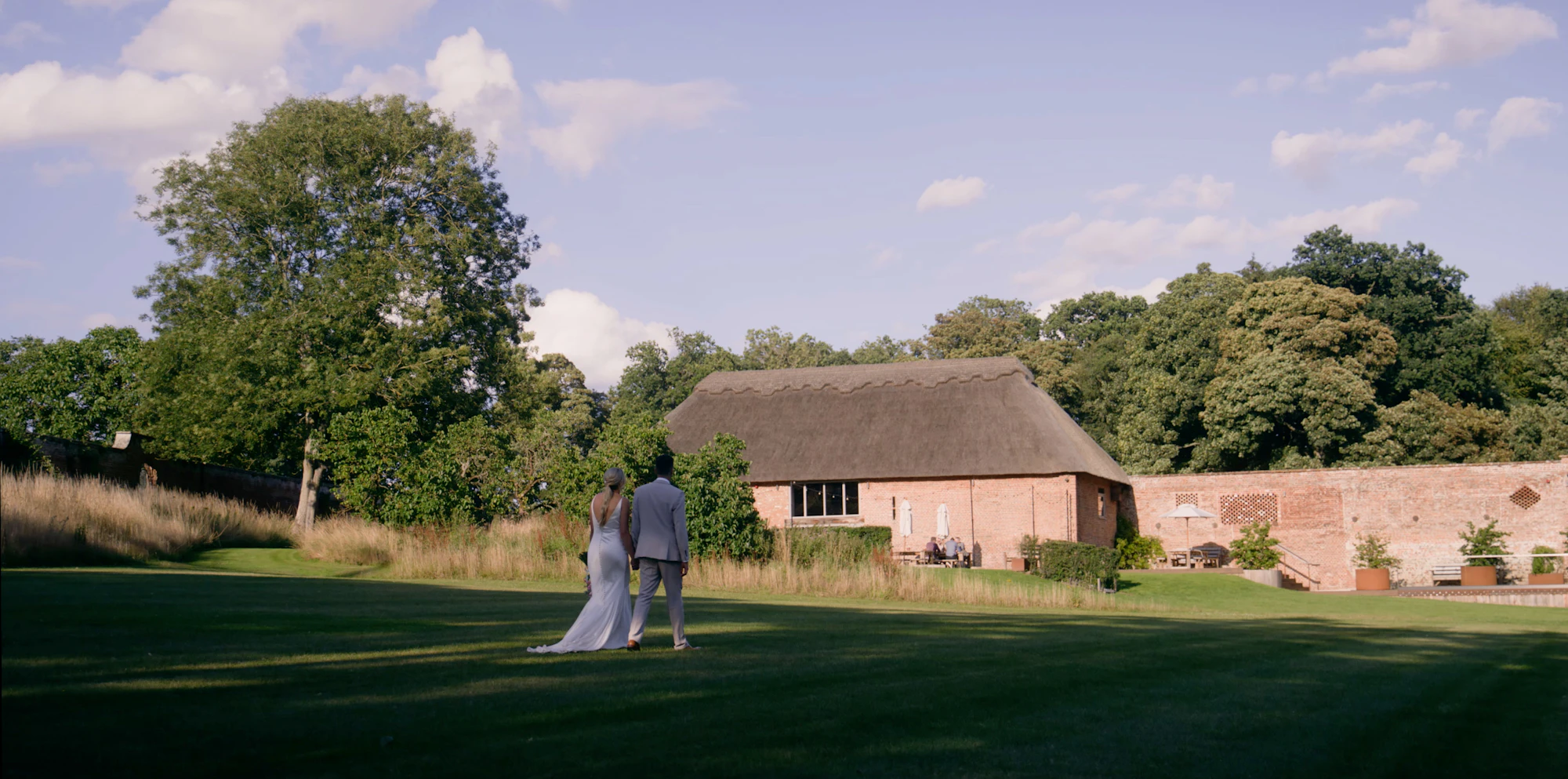 A bride and groom walking together towards their wedding venue