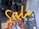 Bright neon signage spells out the word 'Sale', suspended in front of a shop window. The interior shows pairs of shoes displayed on an orange, tiered rack.