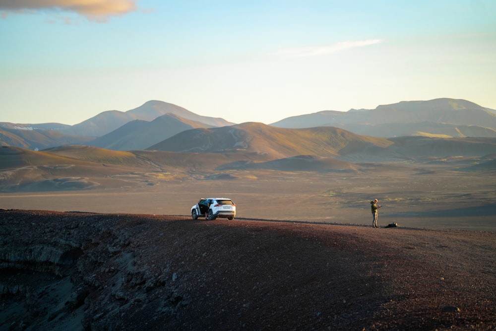 a car is parked on the side of a hill