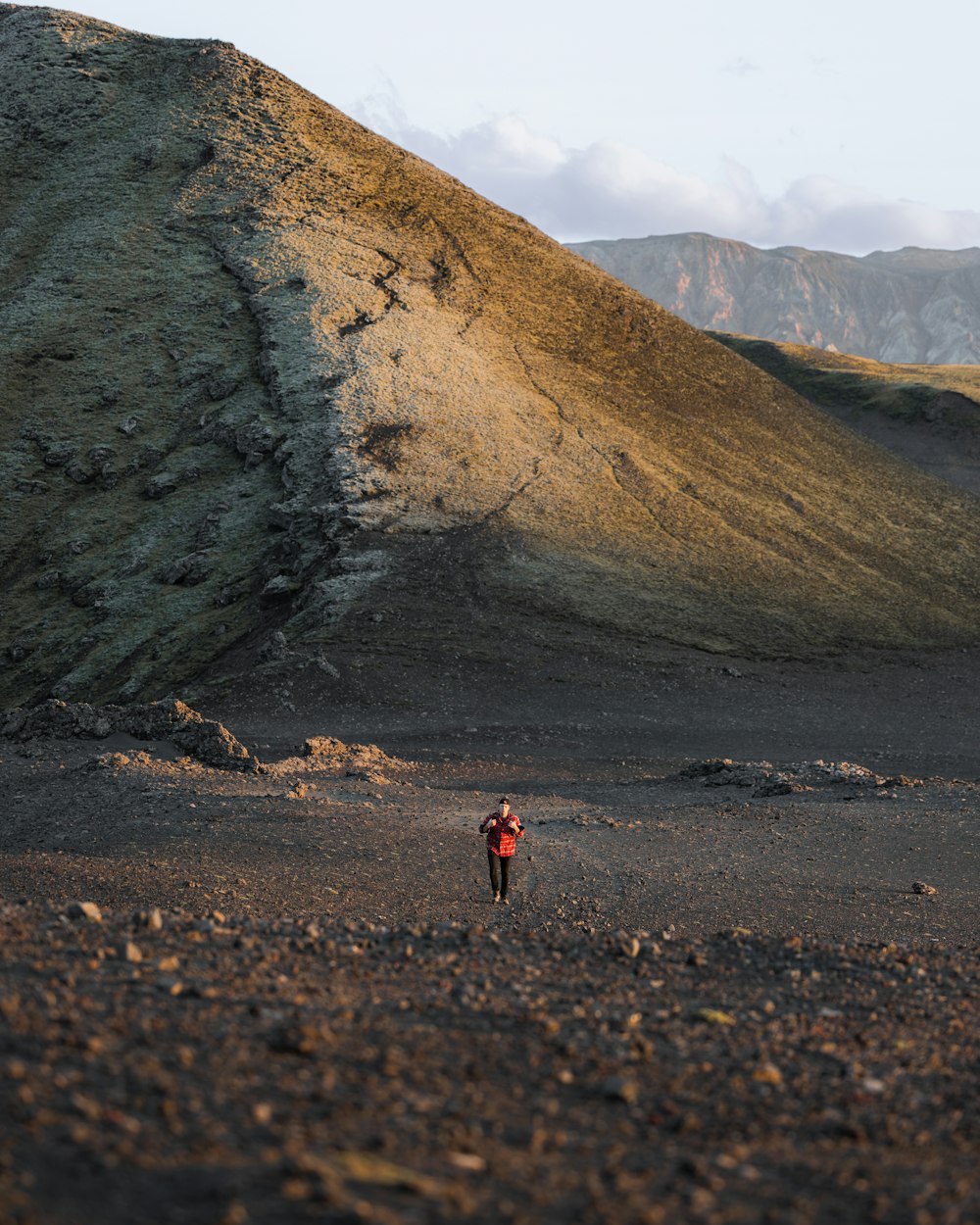 a person standing in the middle of a dirt field