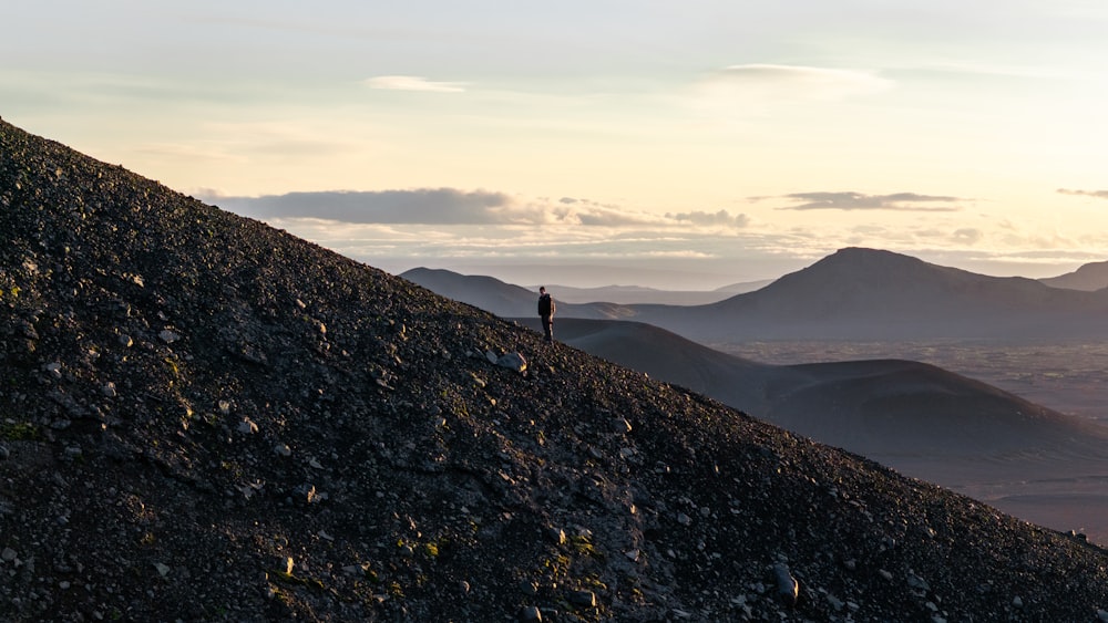 a person standing on top of a rocky hill