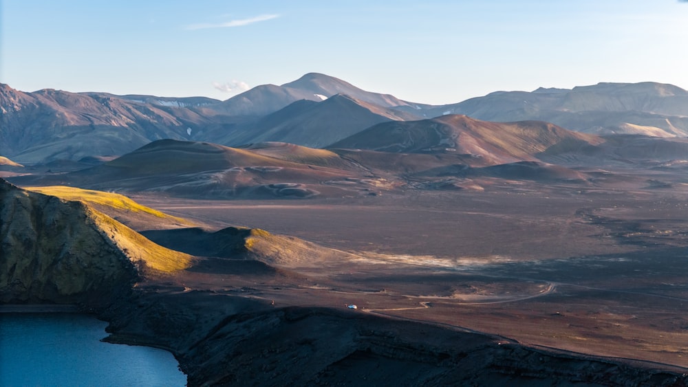 a mountain range with a body of water in the foreground