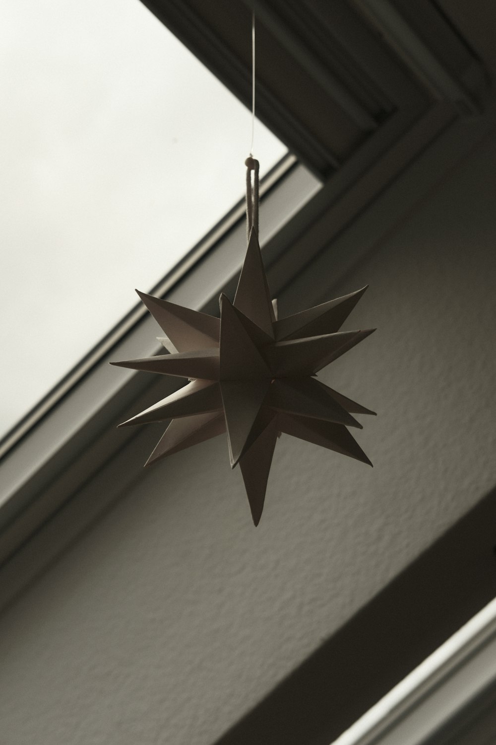 a black and white photo of a paper star ornament