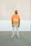 A happy customer wearing a custom-designed t-shirt with a bright orange and dark blue pattern.