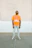 A happy customer wearing a custom-designed t-shirt with a bright orange and dark blue pattern.