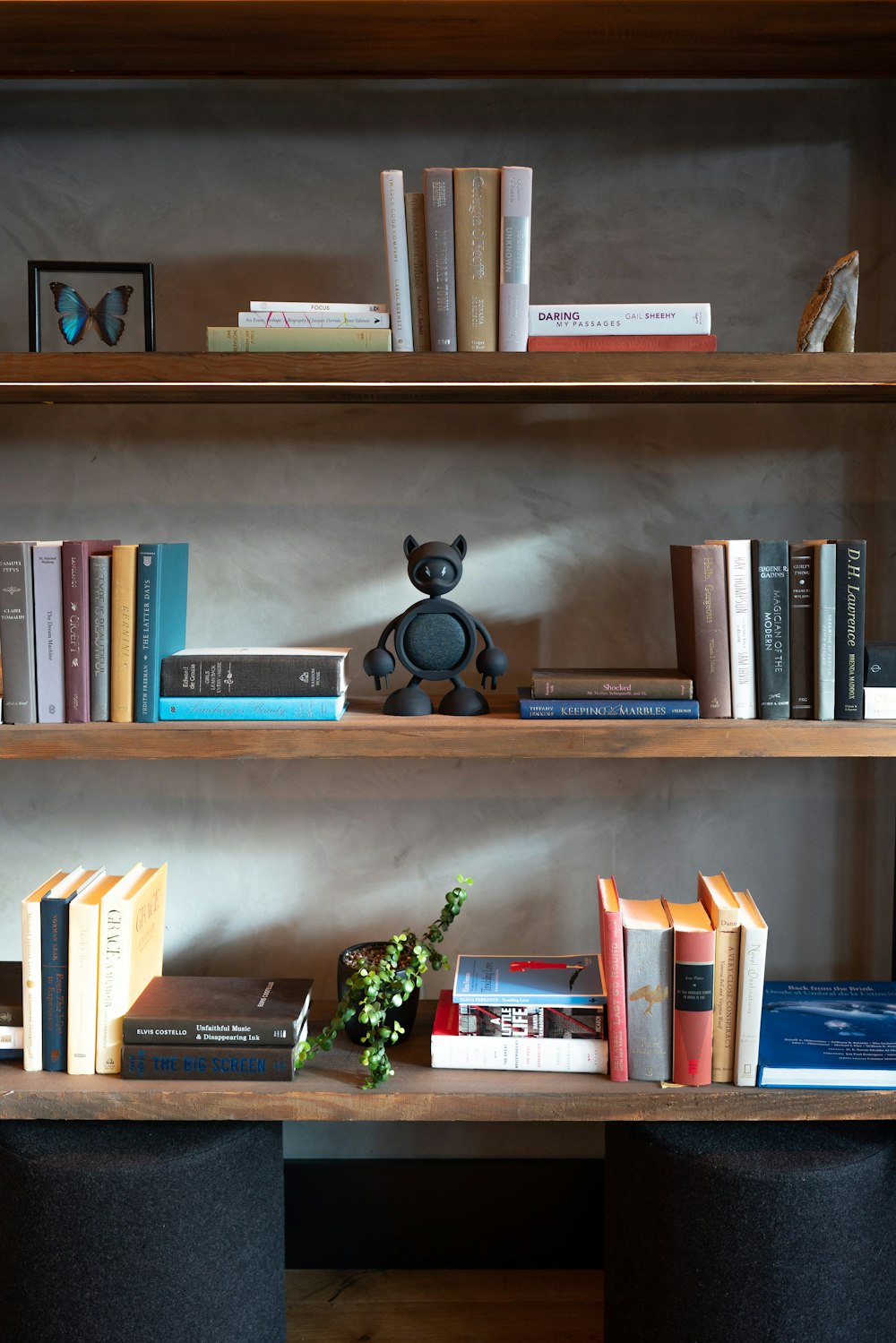 a bookshelf filled with lots of books and a teddy bear