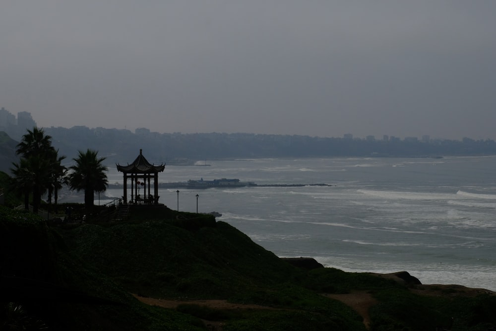 a view of a body of water with a gazebo in the foreground