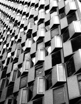 Close-up of textured black and white architectural facade with geometric patterns.