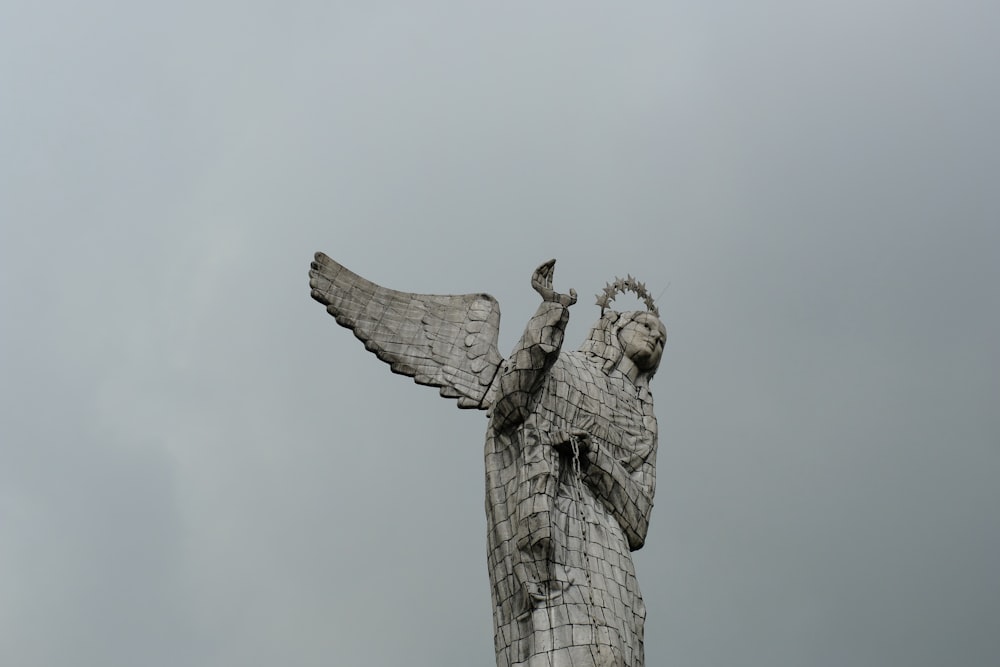 a statue of an angel holding a cross