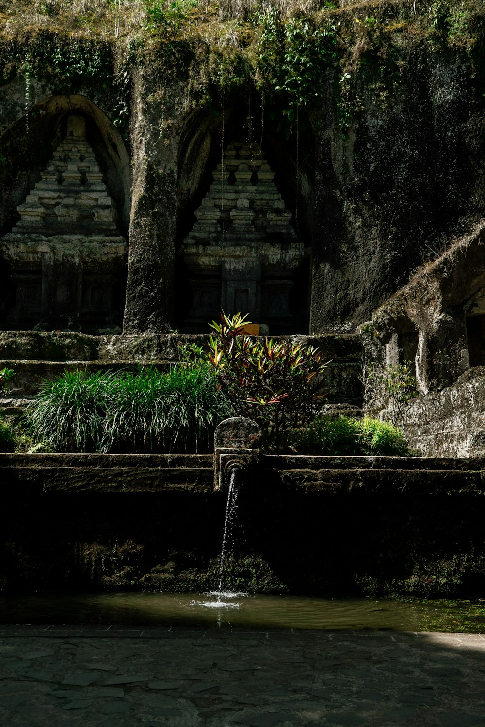 a small waterfall in the middle of a garden