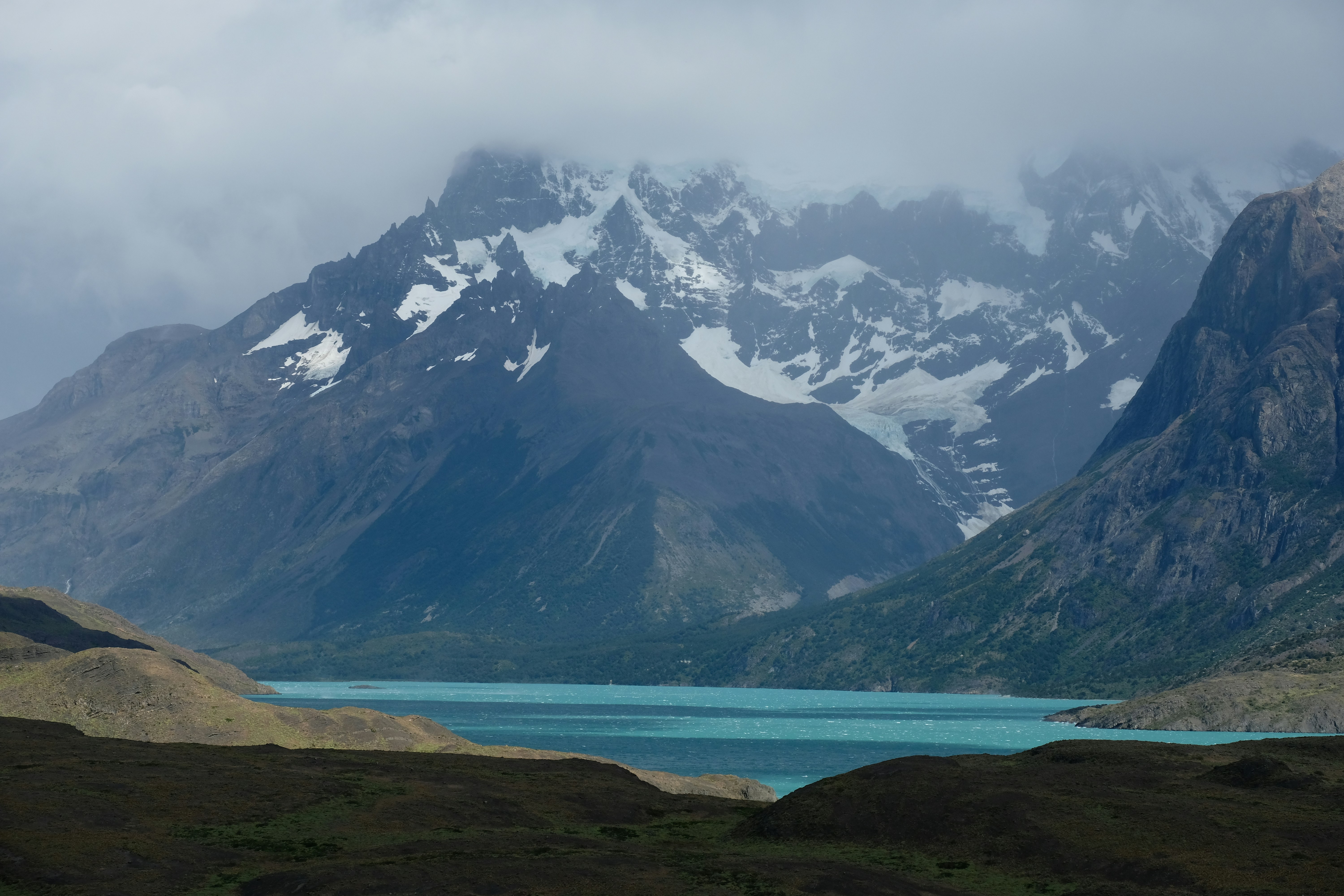 a mountain range with a body of water in the foreground
