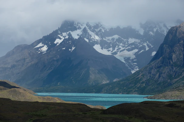 A serene shot of Laguna Humantay’s turquoise waters surrounded by snow-capped peaks.