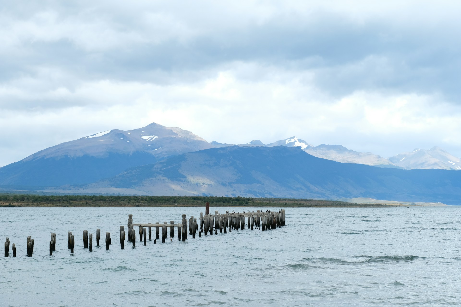 a large body of water with mountains in the background
