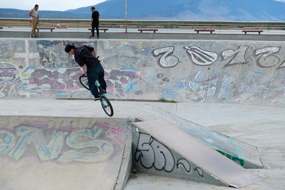 a man riding a skateboard up the side of a ramp