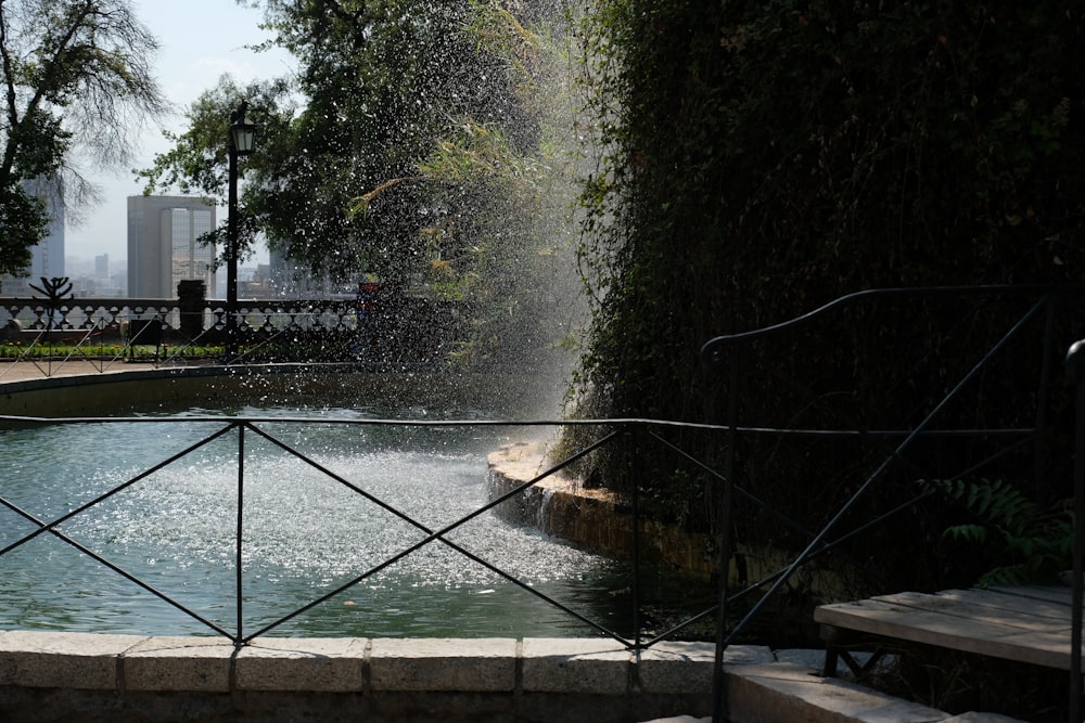 a fountain spewing water into a pool of water