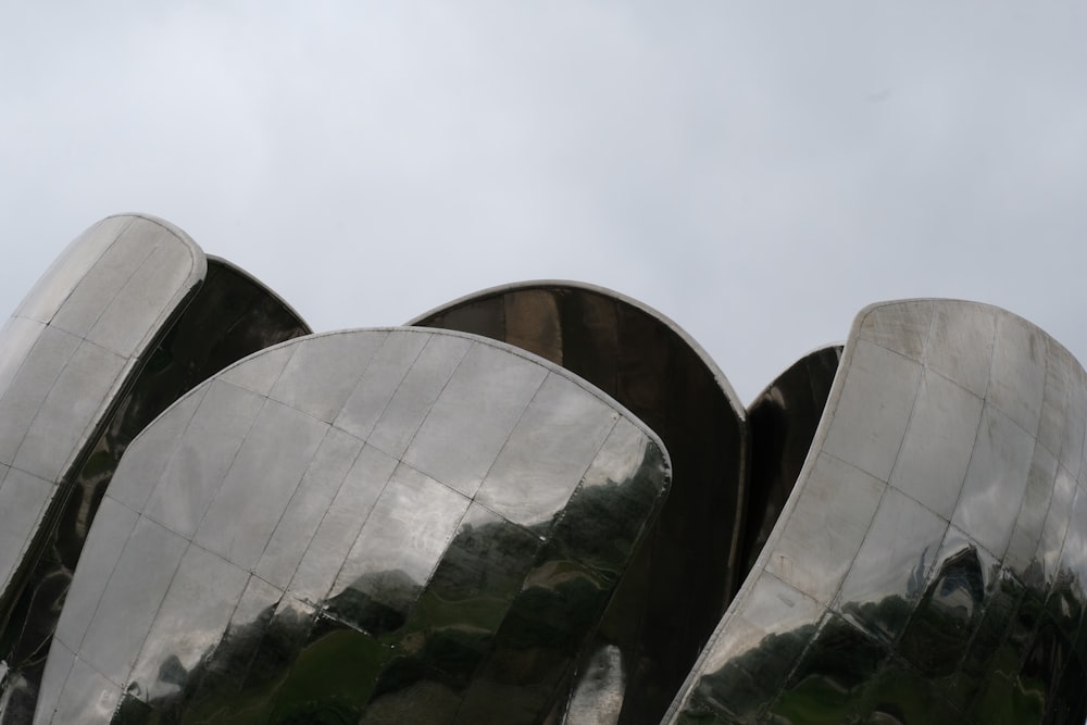 a close up of a metal object with a sky background