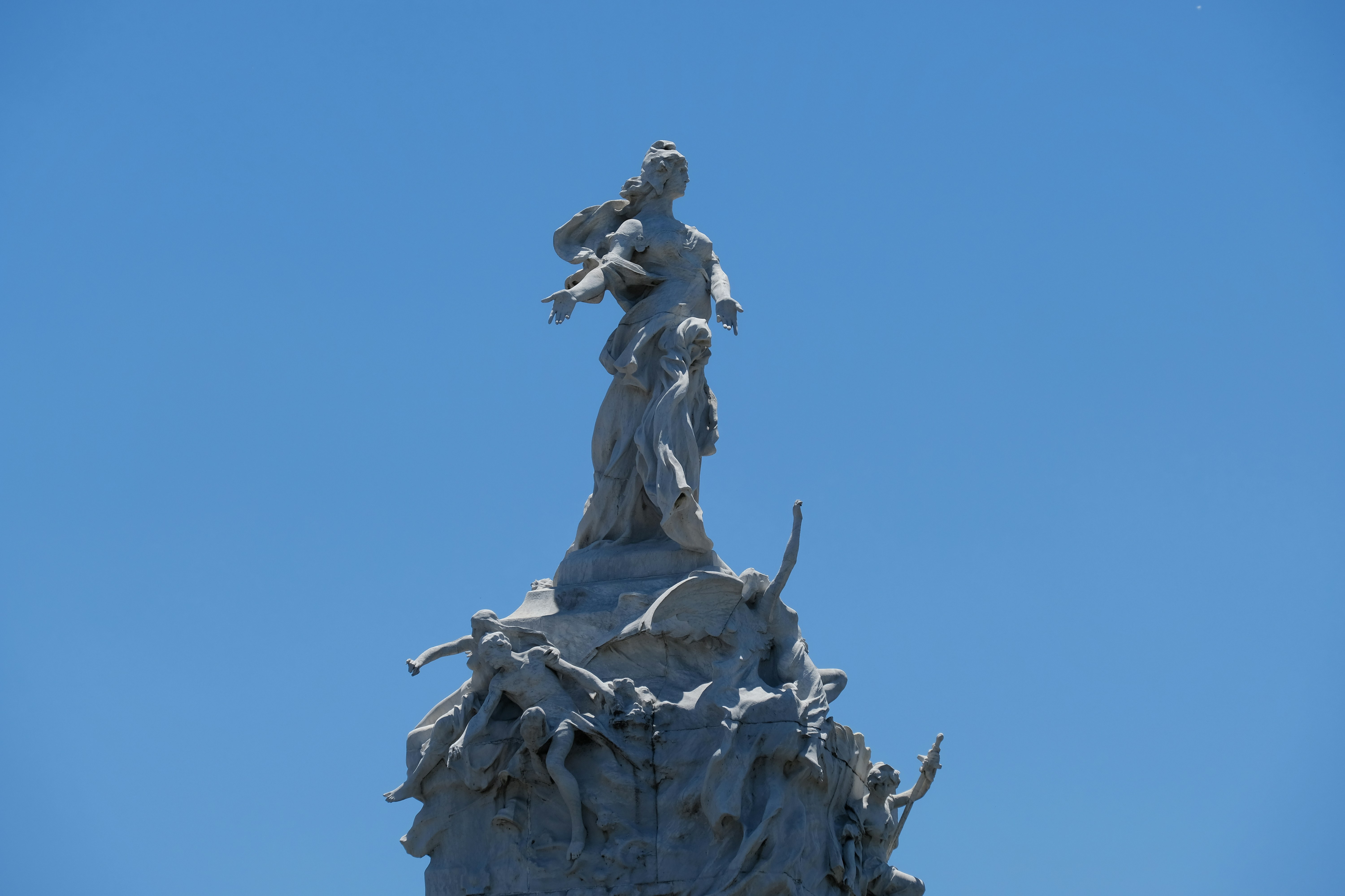 a statue on top of a building with a sky background, 