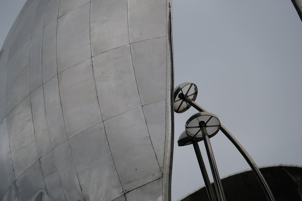 a close up of a metal structure with a sky background