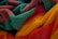 A close-up view of colorful, textured towels featuring vibrant shades of yellow, red, teal, and maroon, intricately folded and piled together.