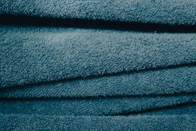 A stack of linen bath towels neatly folded with sunlight highlighting their texture.