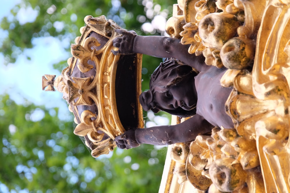 a close up of a statue of a person holding a mirror