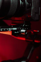 Close-up of a high-end camera setup with metallic details and soft studio lighting.