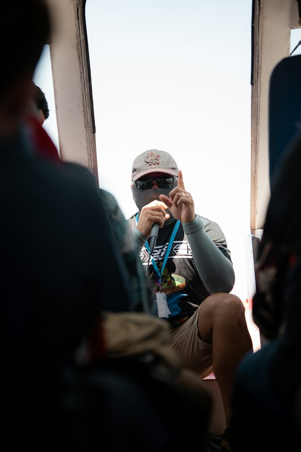 a man wearing a helmet and goggles sitting on a bus