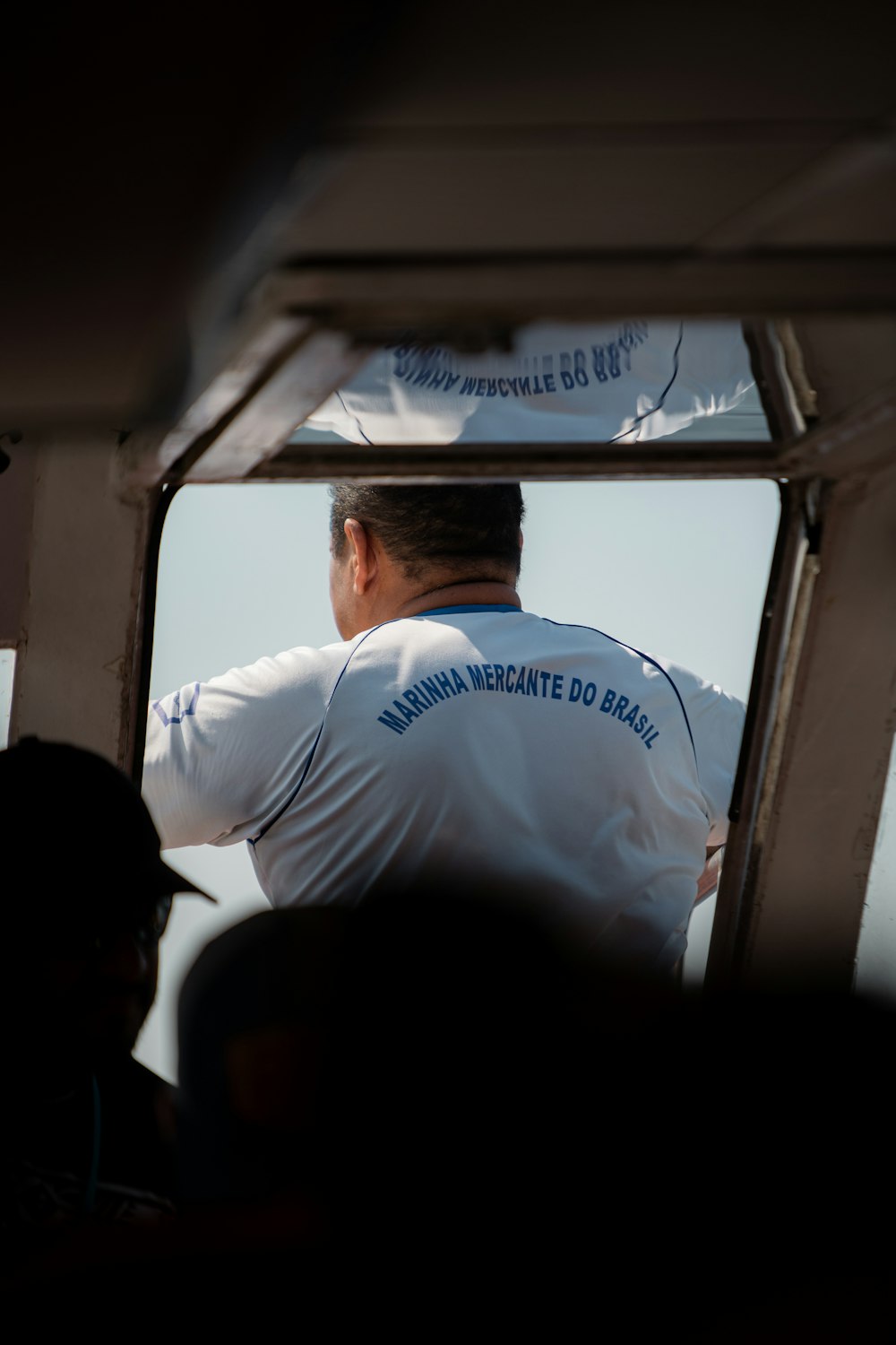 a man in a white uniform standing on a boat