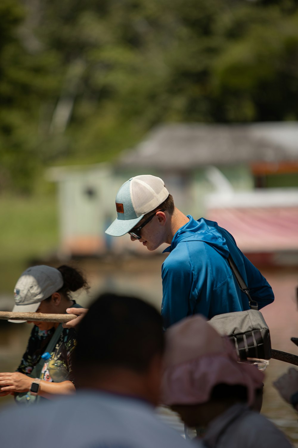 a man in a blue shirt and a white hat