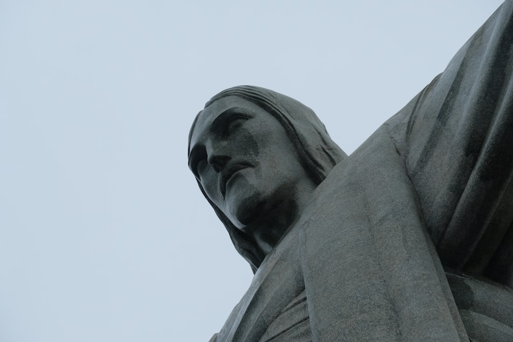 a close up of a statue with a sky background