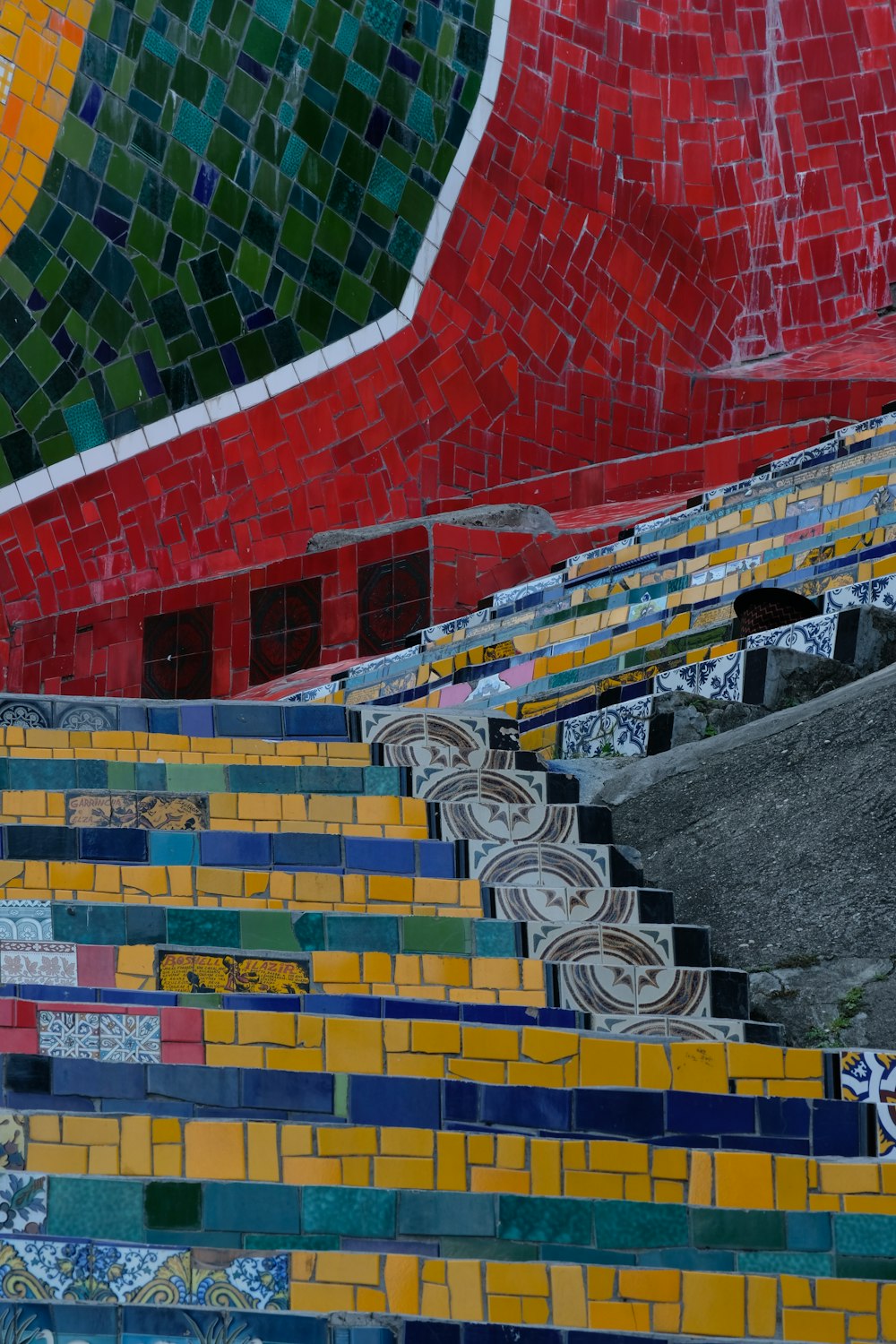 a bunch of colorful tiles on the side of a building