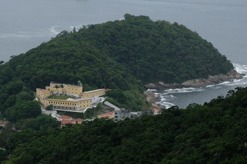 a large yellow building sitting on top of a lush green hillside