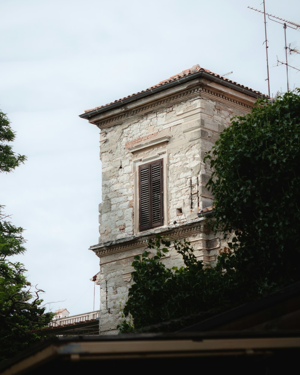 a tall brick building with a clock on it's side