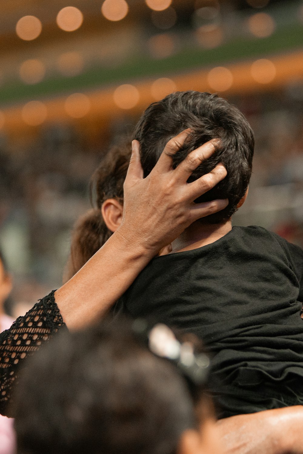 a man covering his face with his hands