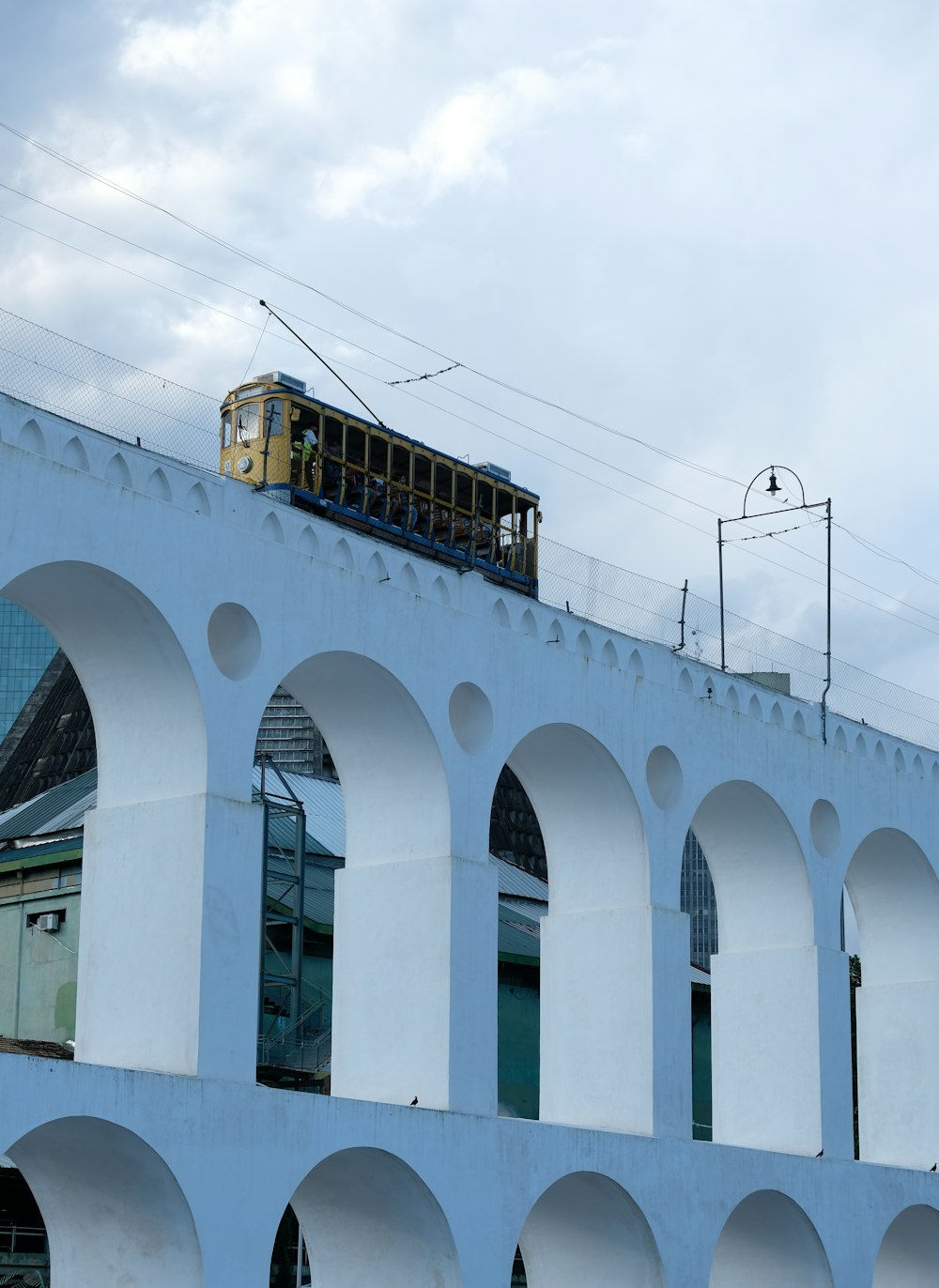 a train traveling over a bridge with arches