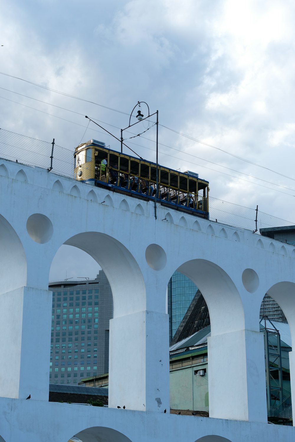 a train traveling over a bridge with arches