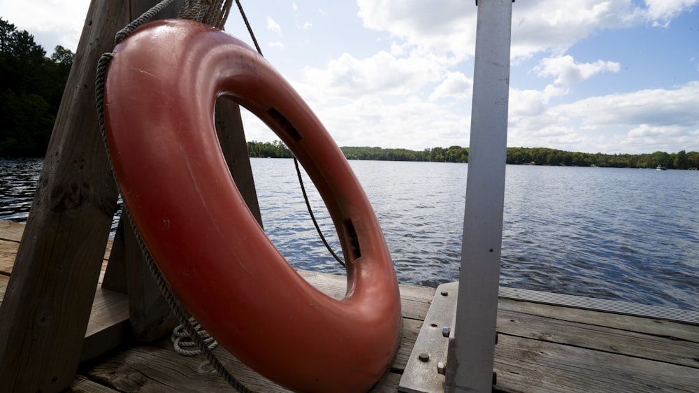 a large red object sitting on top of a wooden dock