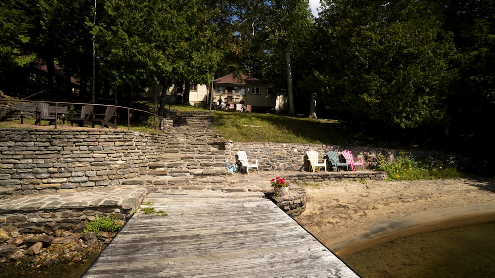 a wooden dock sitting on top of a sandy beach